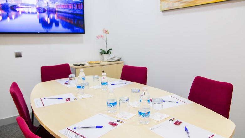 boardroom with oval table for six people